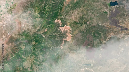 Flying over Cedar Breaks National Monument satellite view with animated clouds based on Nasa imagery