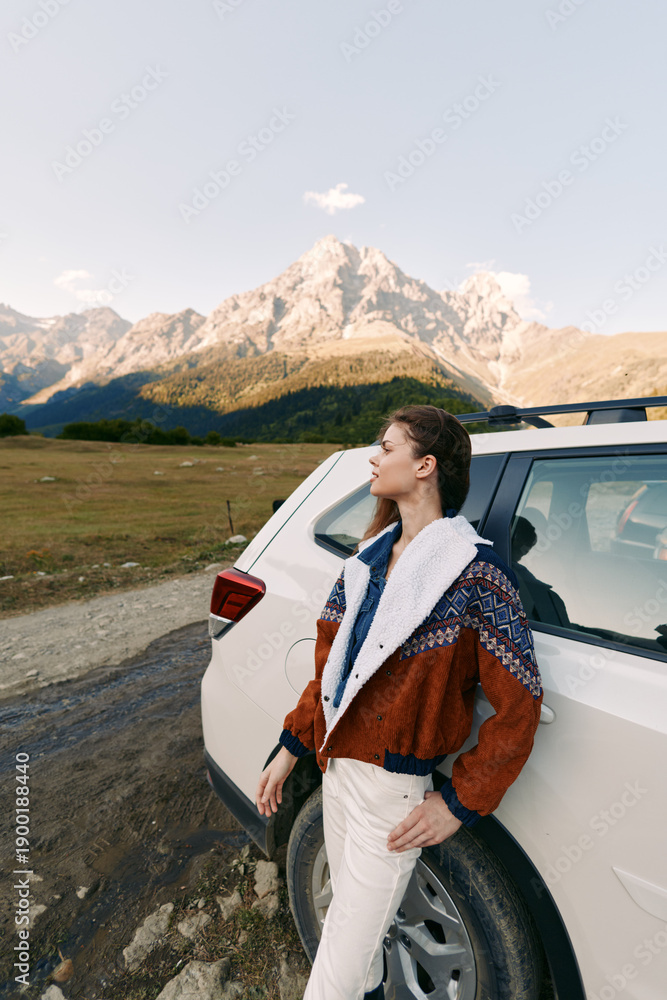 Fototapeta premium Woman and car in mountains on travel roadtrip, portrait in nature with outdoor adventure vibe, leaning by suv on dirtroad, scenic landscape and relaxed exploration journey.