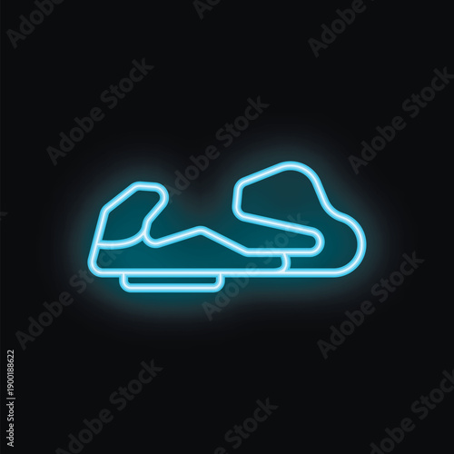 Neon sign illuminating a race track against a dark background, perfect for themes of speed, competition, and motorsport