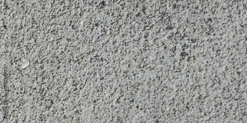 Close up monochrome gray asphalt concrete surface texture featuring rough grain, gritty stone patterns, scattered speckles and subtle tonal variation for abstract background and design overlays.
