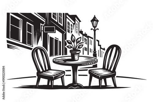 Cafe table with plant and chairs on a street, European ambiance