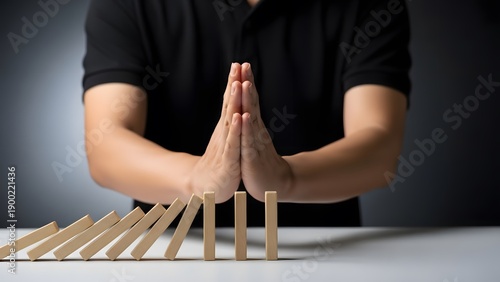 Hands protecting a structure made of wooden matches
