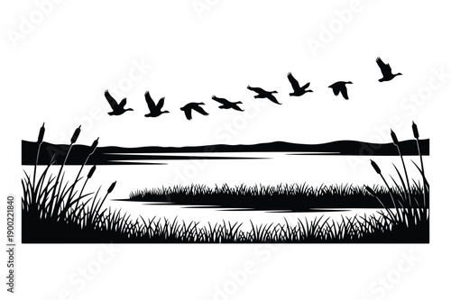 Flock of Geese Flying Over Lake and Reeds Silhouette