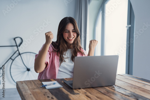 Photos Excited surprised woman looking at laptop screen, reading unexpected good news,