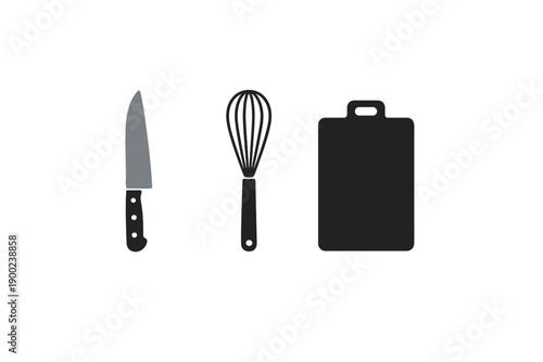 Kitchen tools like knife, whisk, and cutting board are arranged on a clean surface for meal preparation in a home kitchen setting during the morning