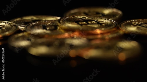 Golden Bitcoin coins symbolising the cryptocurrency market, blockchain technology, and digital finance. Concept of crypto trading, and  investment. 4 k video