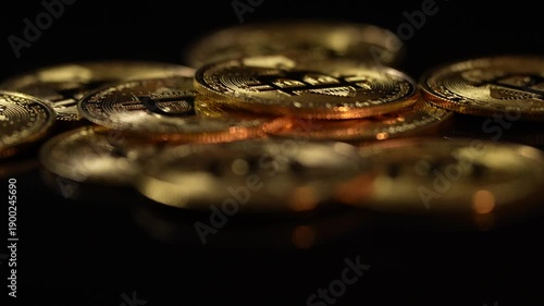 Golden Bitcoin coins symbolising the cryptocurrency market, blockchain technology, and digital finance. Concept of crypto trading, and  investment. 4 k video