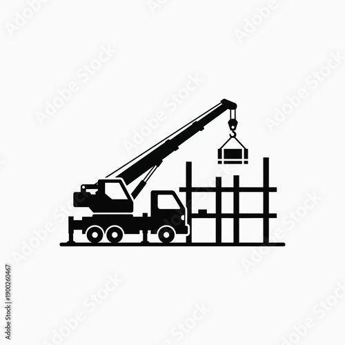 Crane truck lifting heavy load at construction site with building frame