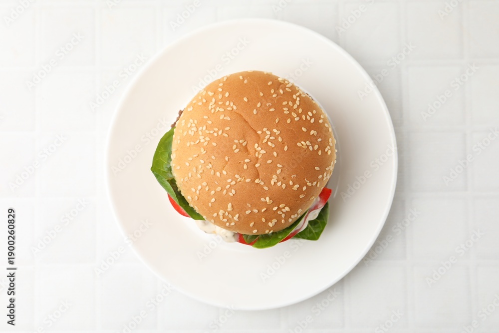 Obraz premium Delicious burger with meat patty on white tiled table, top view