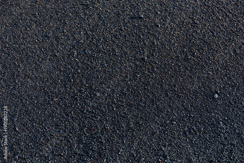 Top down texture of wet black volcanic sand and granules on Reynisfjara Beach, Iceland