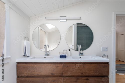 Foto Modern bathroom interior with double sink vanity and round mirrors