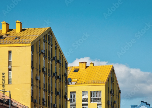 Photography Modern yellow apartment buildings against blue sky
