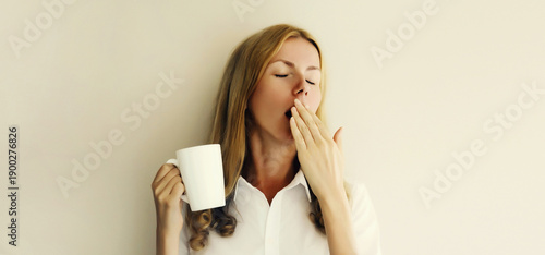 Konstfotografi Sleepy lazy woman yawns waking up after sleeping holds cup of coffee in morning