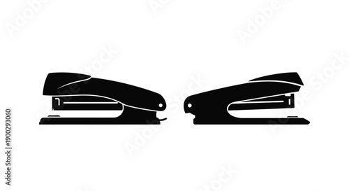 Two black staplers displayed side by side in a dark silhouette