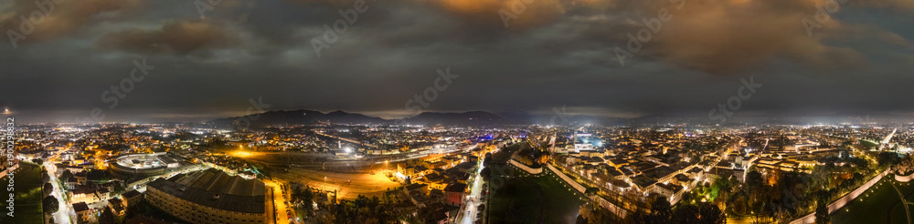 Naklejka premium Panoramic aerial night view of Lucca showing illuminated streets and historic architecture