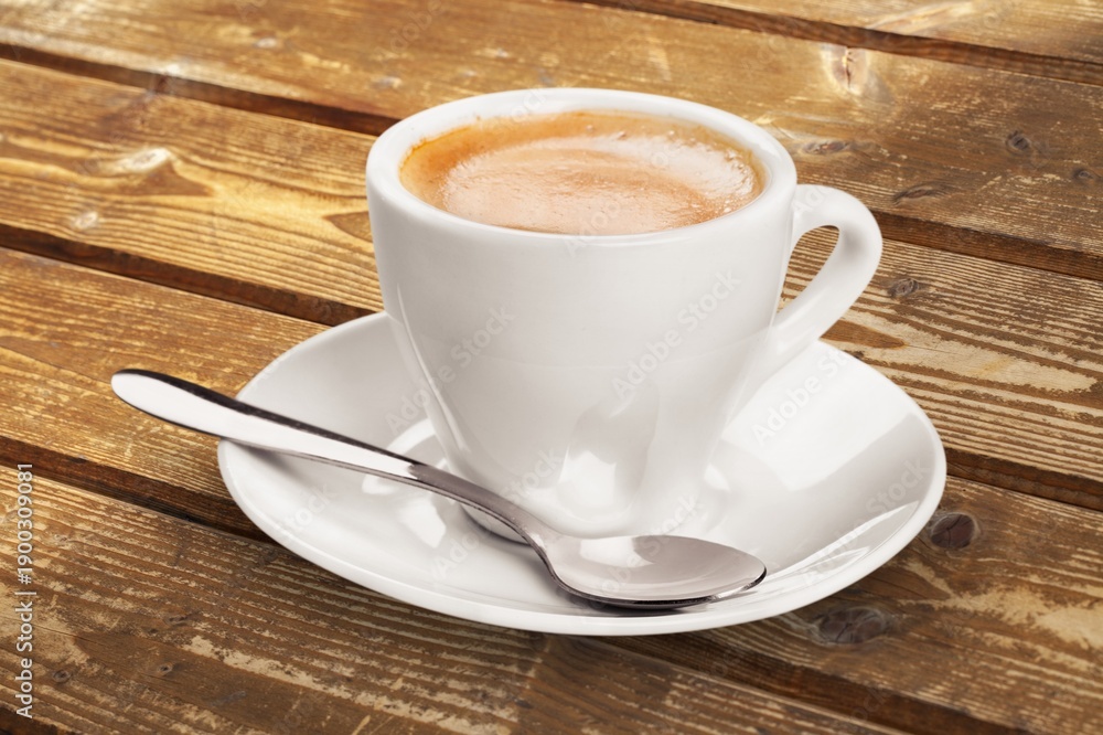 Obraz premium Ceramic white cup with coffee inside.