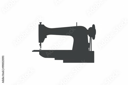 Silhouette of a Sewing Machine: A classic sewing machine in silhouette against a neutral backdrop, ready to create textiles and fashion.