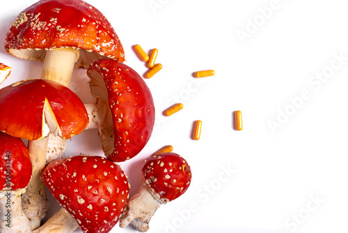 Fotografia Amanita muscaria mushroom extract in yellow capsules, alternative medicine conce