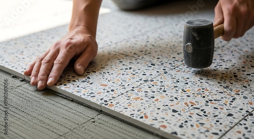 Precision tile installation, a craftsman meticulously sets modern flooring