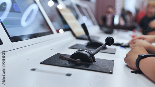 Fotografia Person operating power levers in a modern flight simulator control panel