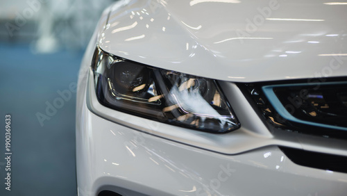 Tableau sur toile White car headlight close up showing modern vehicle design and technology