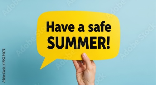 Safe Summer Wishes: Hand Holding Yellow Speech Bubble on Blue Background, Cheerful and Encouraging Message