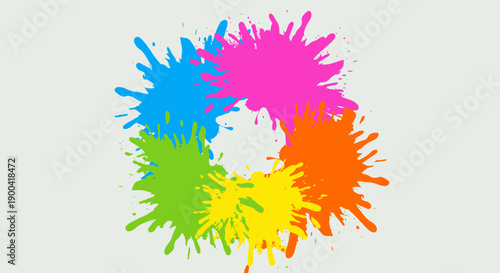 Vibrant colored splatters forming a circular pattern viewed from directly above a creative artwork