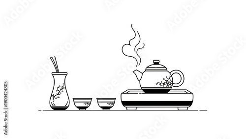 Traditional Japanese tea set with steaming teapot and cups