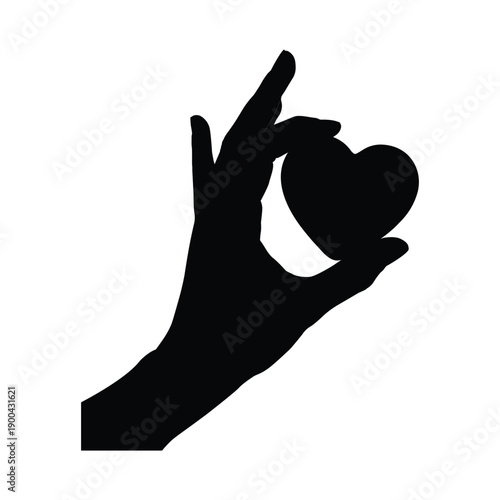 Silhouette of a hand delicately holding a small heart shape against a white background
