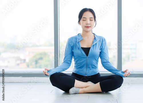 Free Download Asian young beautiful happy woman fit sporty slim healthy in sportswear practicing sitting yoga in lotus pose feeling contemplation meditating while training in bright fitness gym wellness lifestyle. - GFXLoad