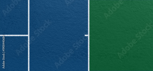 Blue and green tennis court surface with clear white boundary lines and textured hard court material