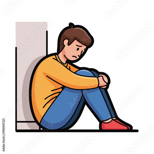 A man sits with his knees drawn up