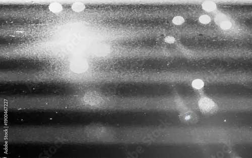 blurry winter background features rain drops on the window with blue holiday bokeh lights and silver glitter patterns for a shiny Christmas design.