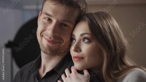 Loving couple embracing indoors with a blurred background