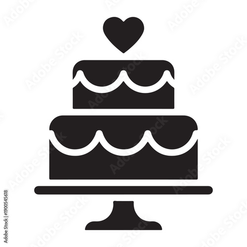 A simple, black silhouette icon depicts a two-tiered cake on a pedestal stand. The cake features decorative scalloped lines on each tier and is topped with a single heart-shaped decoration. 