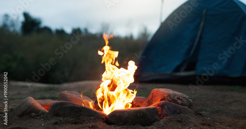 Photos Night, tent and wood with flames for bonfire, smoke and embers burning for camping travel holiday