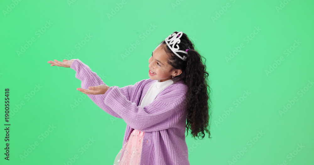 Fototapeta premium Costume, pointing and princess with girl on green screen background for dress up announcement. Crown, hand gesture and smile of female child isolated on studio mockup space for deal or notification