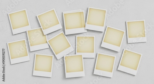 Collection of Polaroid photos scattered randomly on a gray surface viewed from directly above