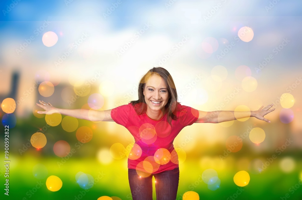 Obraz premium Young woman on field under sunset light