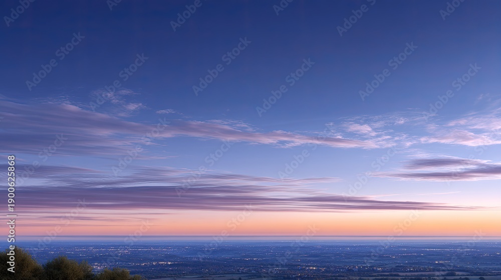 Fototapeta premium Serene Sunset Over Calm Horizon with Colorful Sky and Soft Clouds Reflecting Light in Beautiful Twilight Atmosphere for Landscape Photography