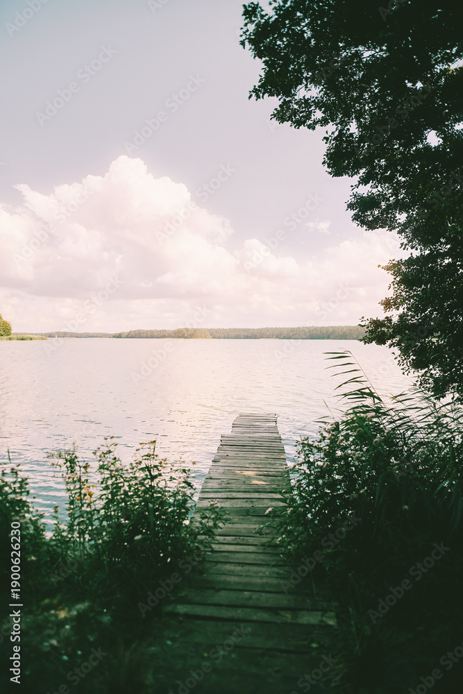 Fototapeta premium Tranquil lake with old wooden jetty