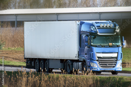 Fotografi Large white semi truck on rural highway