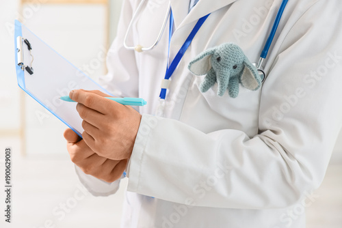 Male pediatrician with toy ...