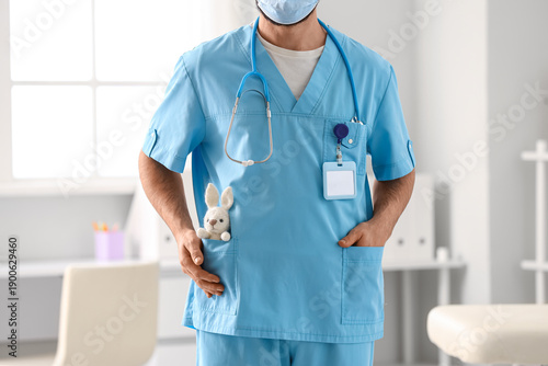 Male pediatrician with toy ...
