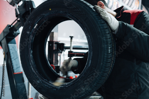 Mechanic Repairing Tire at Auto Service Shop