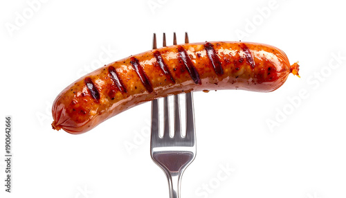 A single grilled sausage impaled on a fork, isolated against a solid black backdrop