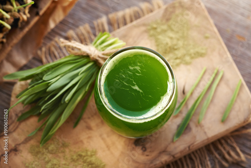 фотографія Fresh green barley grass juice with homegrown barleygrass blades
