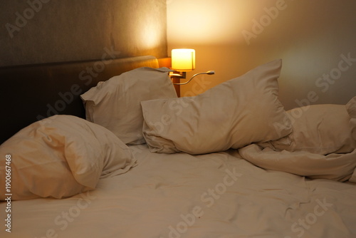 Pillows on hotel bad with warm light