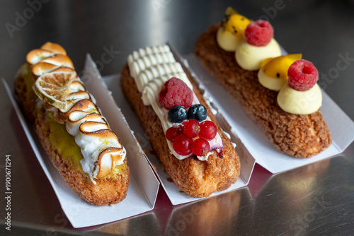 Three Gourmet Éclairs with Berry and Passion Fruit Flavors
