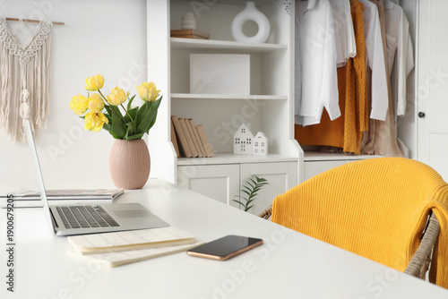 Laptop and vase with spring...